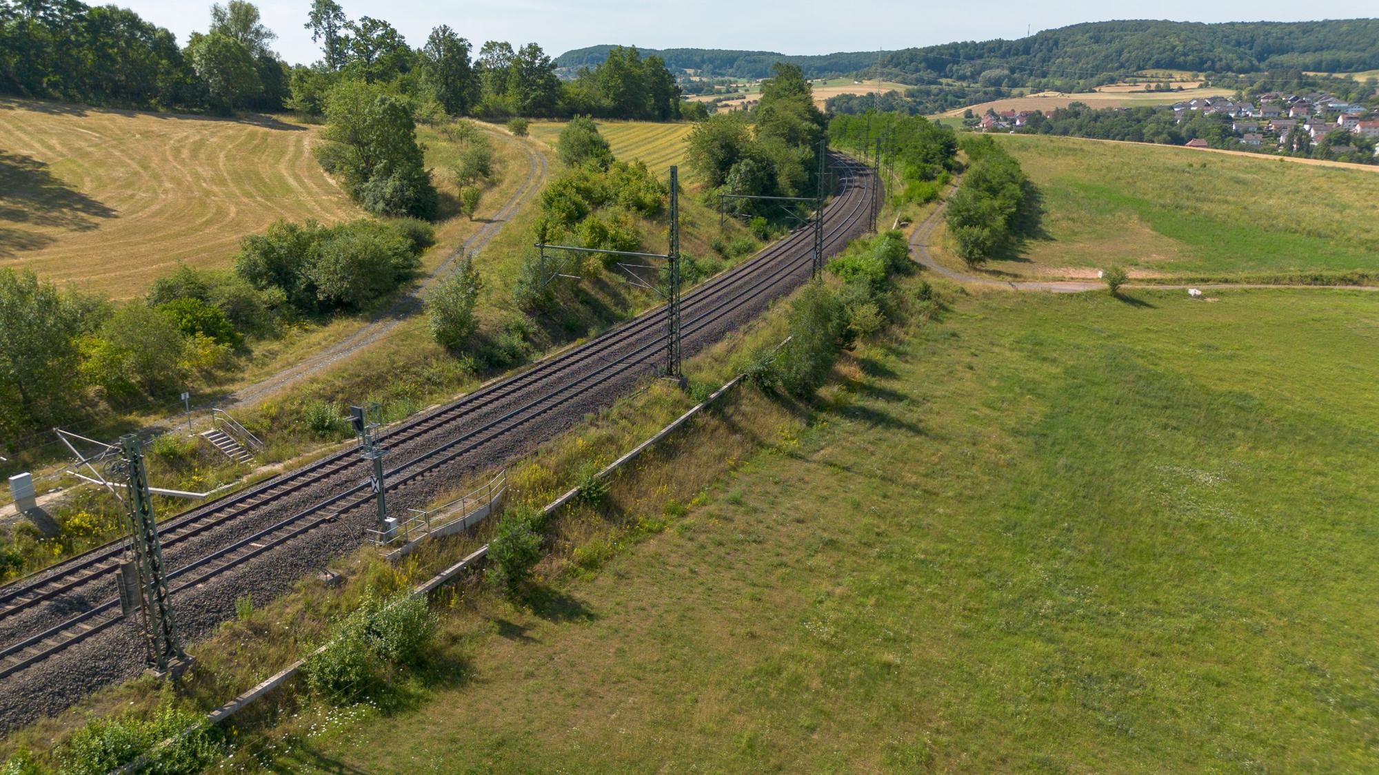Rail line curving through farmland
